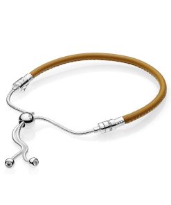 Silver sliding bracelet with golden tan bracelet and clear cubic zirconia